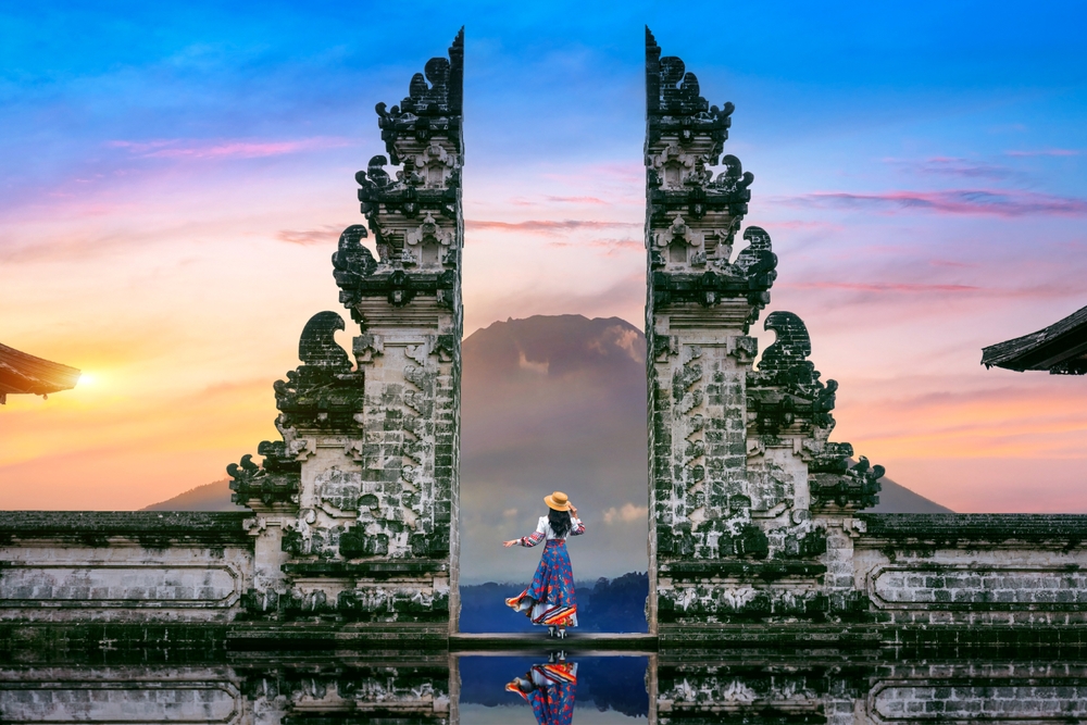 Young,Woman,Standing,In,Temple,Gates,At,Lempuyang,Luhur,Temple